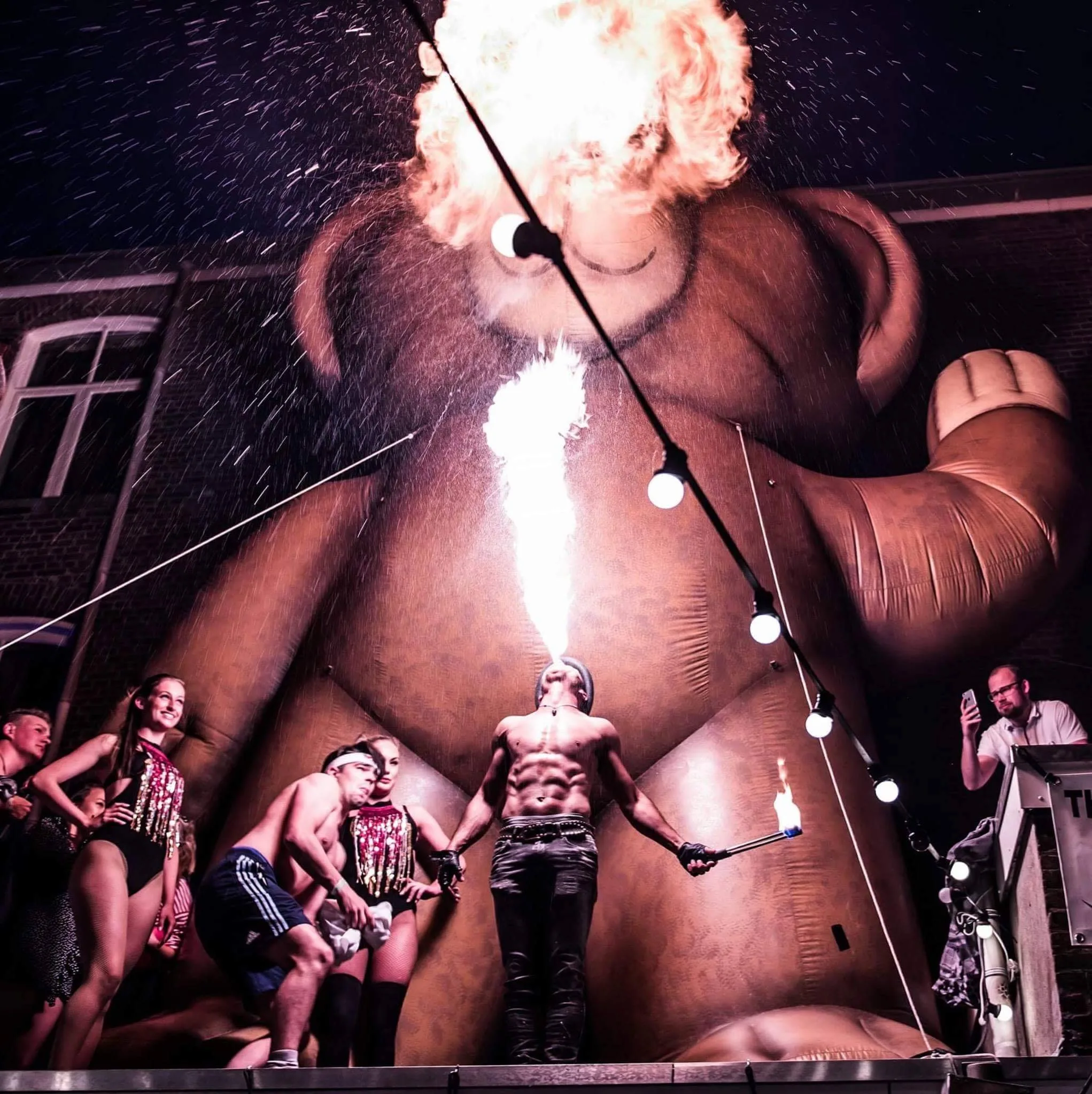 fire show masquerade ball – Nuno breathes fire during an atmospheric masquerade ball with costumed guests
